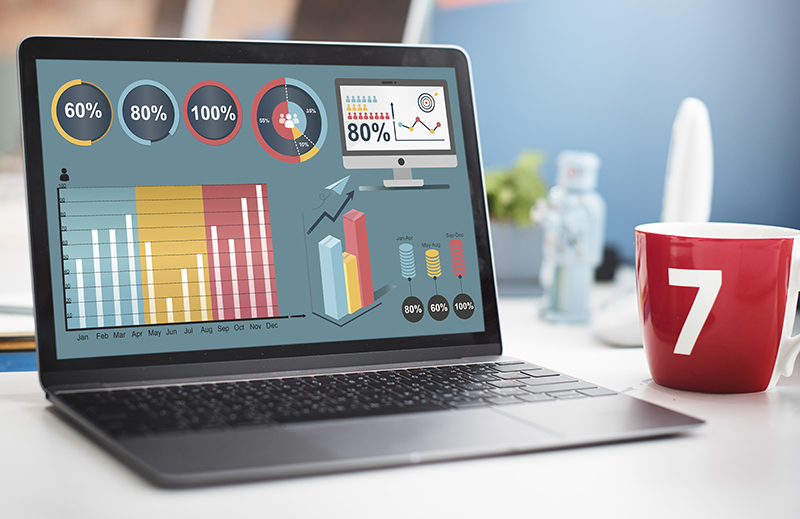 A laptop with some bar graphs and performance meter showing analytics of a website